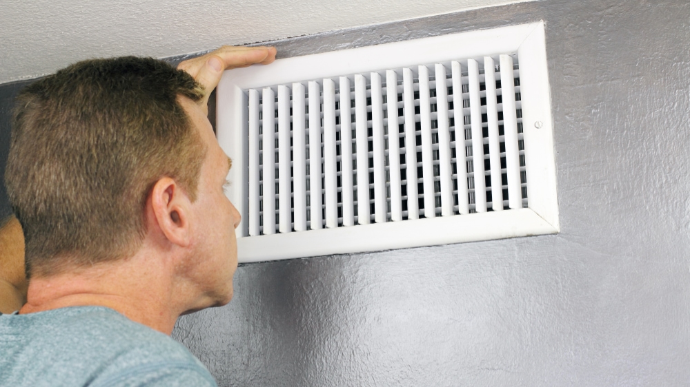 Inspecting home air vent.