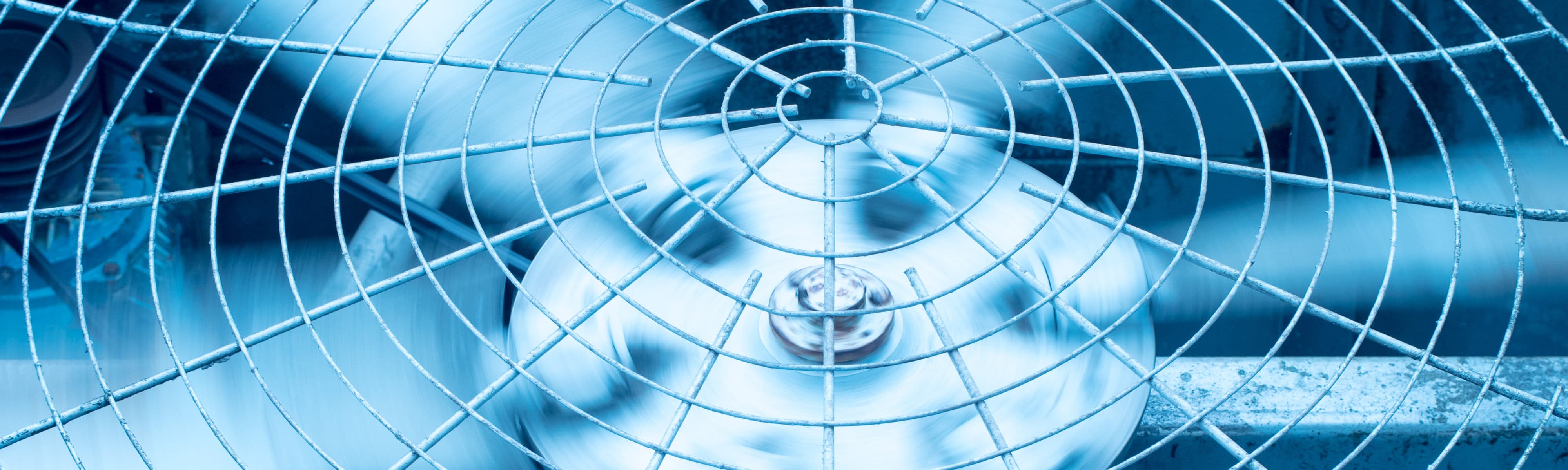 Close-up of air conditioner fan blades spinning.