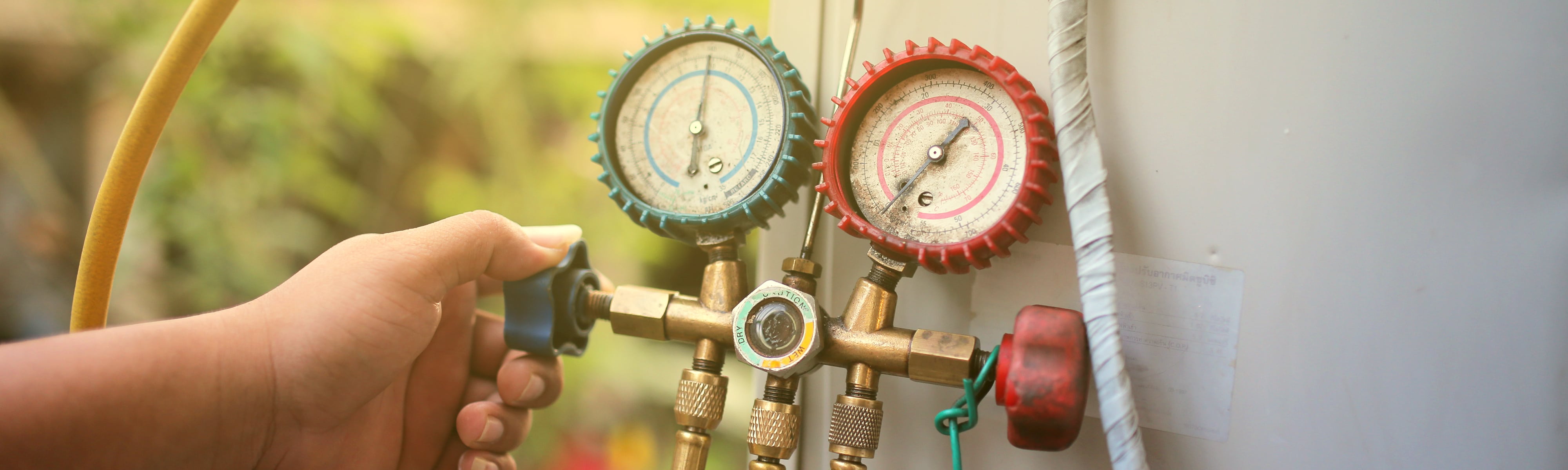 Technician using gauges.