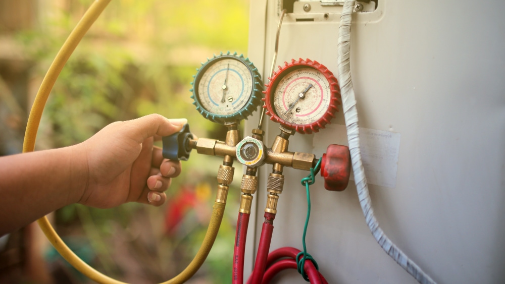 Technician using gauges.