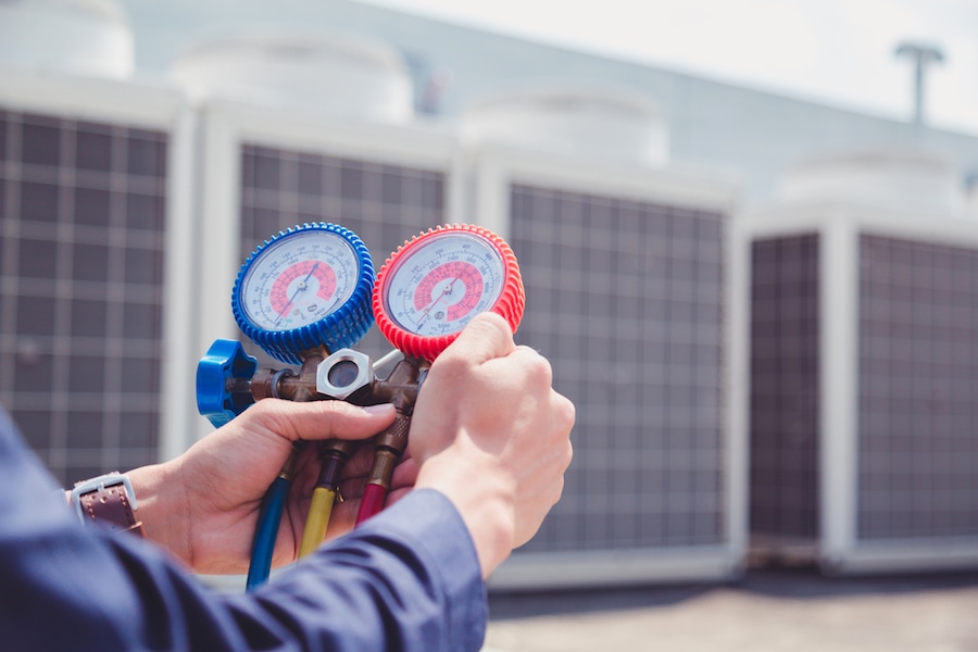 Technician is checking air conditioner ,measuring equipment for filling air conditioners.