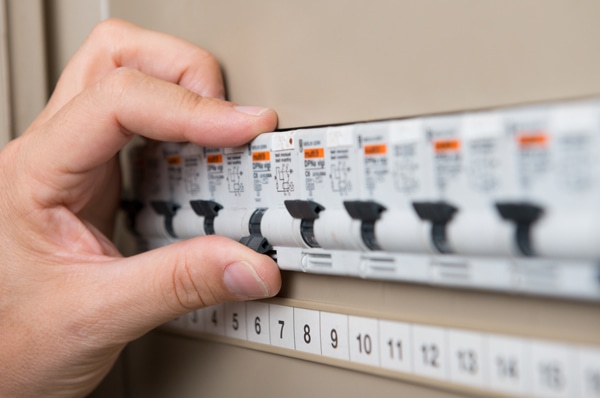 Closeup Of Person's Hand Repair The Switchboard