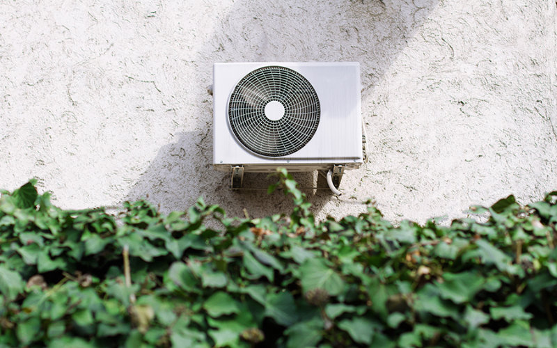 A split-system A/C unit in an Olympia, WA homeowner's backyard.