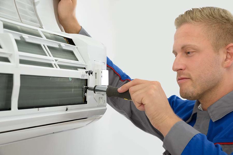 Technician Repairing Air Conditioner, Do I Really Need an AC Tune-Up? | Repair, Maintain | Olympia, WA