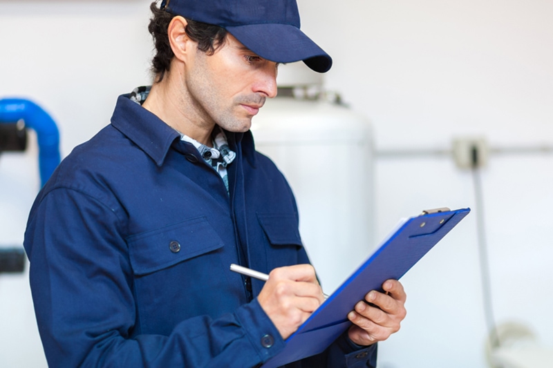 man performing a furnace inspection