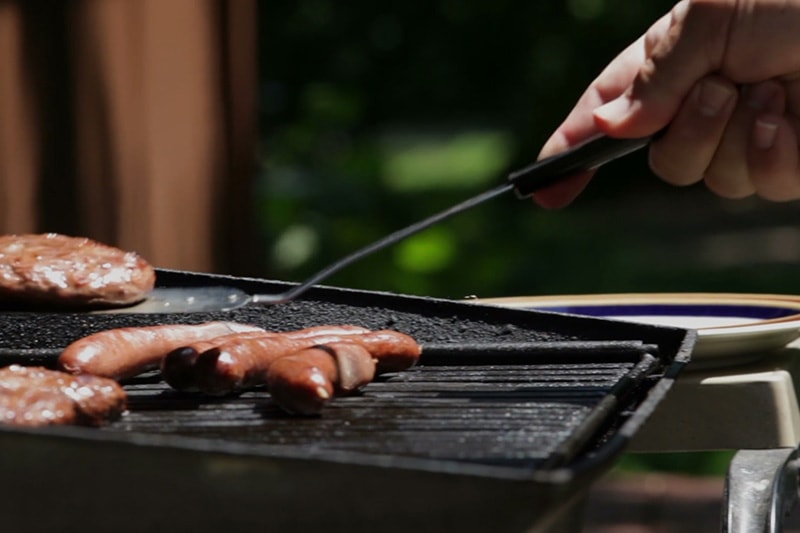 grilling some hamburgers and hotdogs