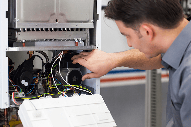 repair man working on a heat pump system