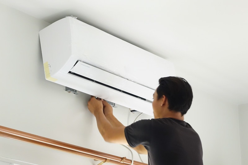 man installing a ductless system.