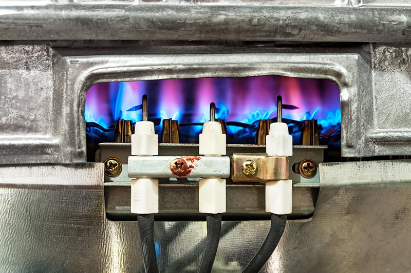 close-up of a gas furnace pilot light.
